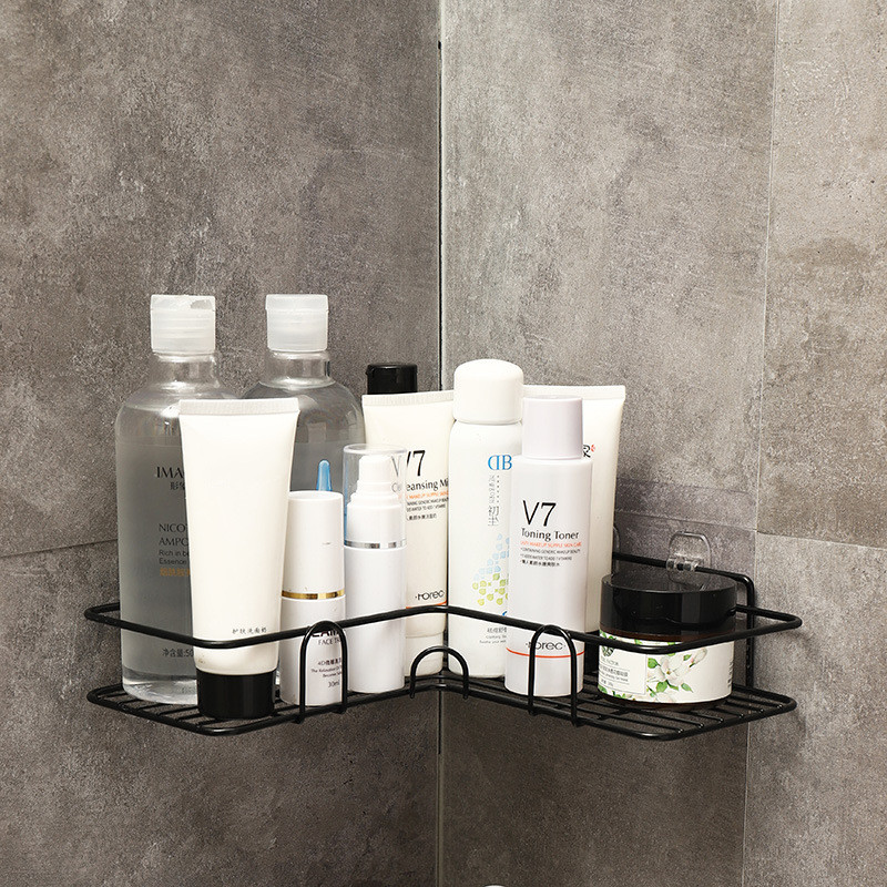 Black corner shower shelf holding bottles